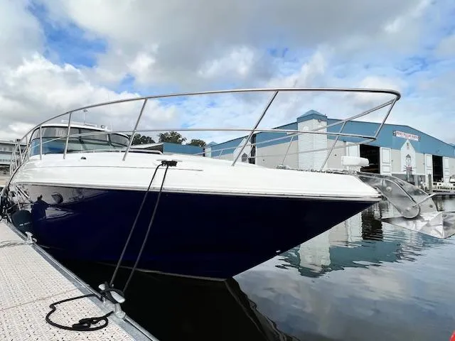 Slide: The Image of 2005 Sea Ray 500 Sundancer yacht docked at marina, reflecting on calm water. - 6