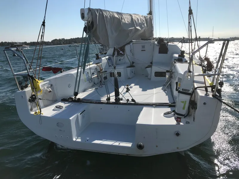 Slide: The Image of 2023 Jeanneau Sun Fast 3300 sailboat on water, rear view, sunny day. - 17