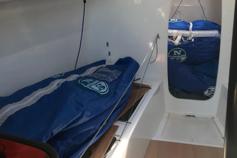 Slide: The Image of Interior of 2023 Jeanneau Sun Fast 3300 sailboat with blue sail bags. - 22