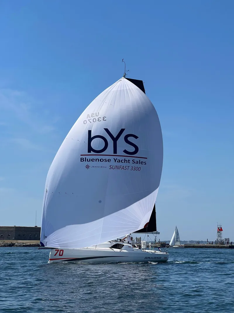 Slide: The Image of 2023 Jeanneau Sun Fast 3300 sailing with large spinnaker in open water. - 6