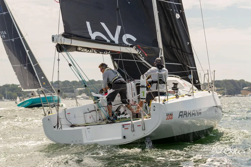 Slide: The Image of 2023 Jeanneau Sun Fast 3300 sailing on open water with crew onboard. - 7