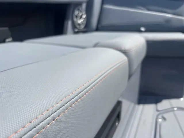 Slide: The Image of 2023 Axis Wake Research T220 boat interior with gray upholstery and orange stitching. - 11