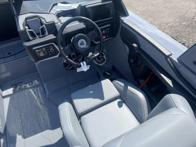 Slide: The Image of 2023 Axis Wake Research T220 boat interior with steering wheel and dashboard. - 12