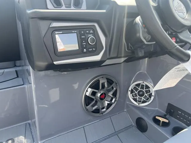 Slide: The Image of 2023 Axis Wake Research T220 boat dashboard with audio controls and speakers. - 14