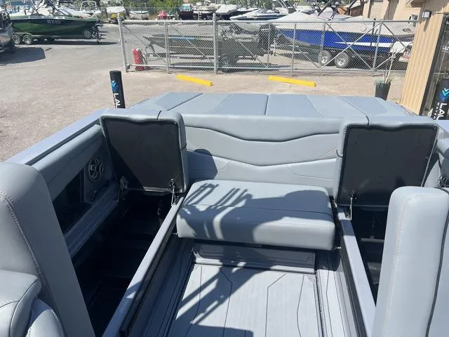 Slide: The Image of 2023 Axis Wake Research T220 boat interior with gray seating and storage compartments. - 16