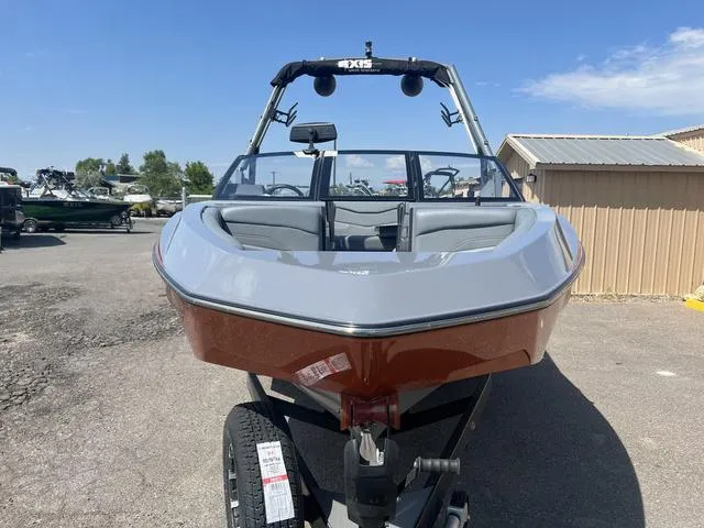 Slide: The Image of 2023 Axis Wake Research T220 boat on trailer, front view, outdoor setting. - 3