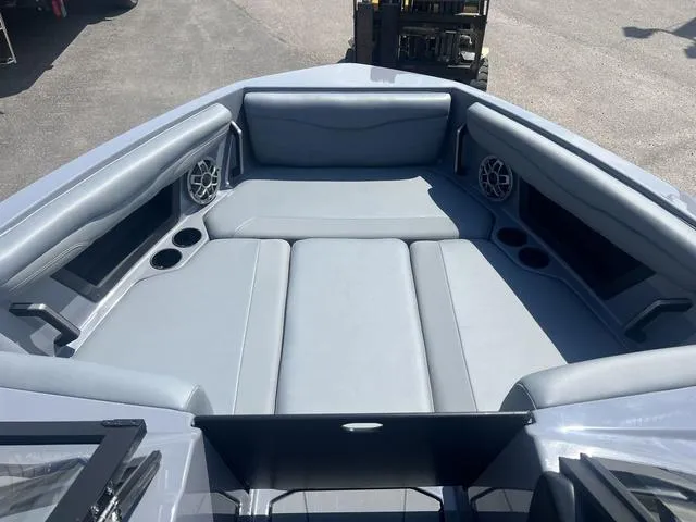 Slide: The Image of 2023 Axis Wake Research T220 boat interior with gray seating and built-in speakers. - 6