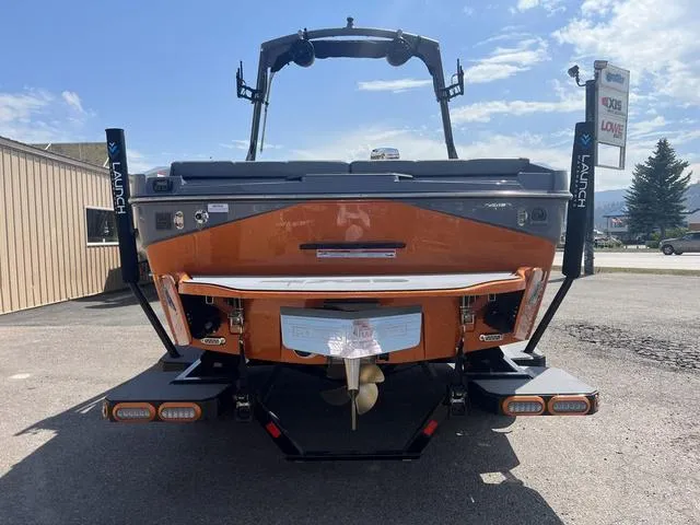 Slide: The Image of 2023 Axis Wake Research T220 boat rear view in parking lot. - 7