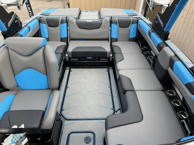 Slide: The Image of 2021 Malibu M220 boat interior with blue and gray seating. - 10