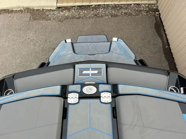 Slide: The Image of 2021 Malibu M220 boat rear deck and seating area with blue accents. - 6