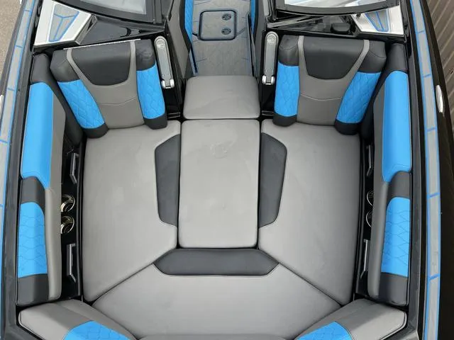 Slide: The Image of 2021 Malibu M220 boat interior with blue and gray seating. - 8