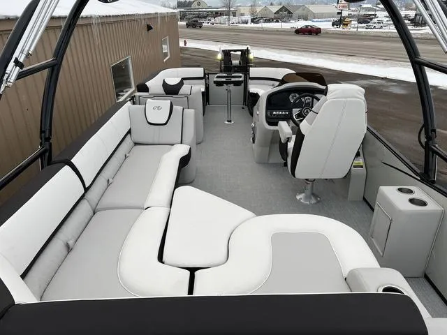 Slide: The Image of 2023 Avalon 25 Catalina Rear J Lounger boat interior with luxurious seating and modern helm. - 10