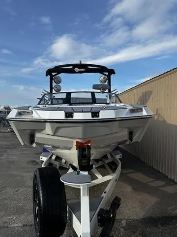 Slide: The Image of 2023 Malibu M240 boat with sleek design and spacious seating. - 3