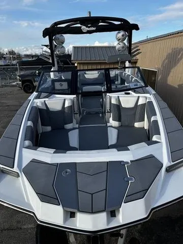 Slide: The Image of 2023 Malibu M240 boat with spacious seating and modern design. - 4