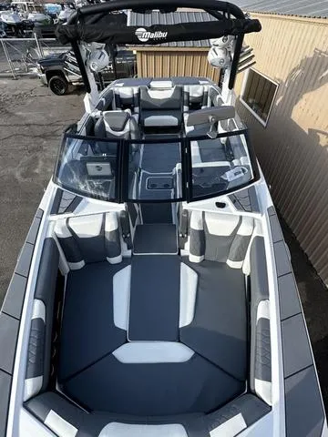 Slide: The Image of 2023 Malibu M240 boat cockpit with modern steering wheel and touchscreen display. - 6