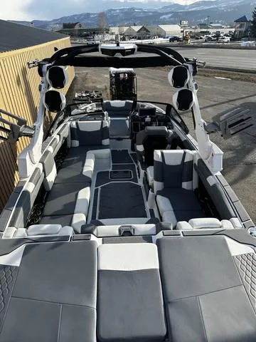 Slide: The Image of 2023 Malibu M240 boat rear view with wakeboard racks and swim platform. - 8