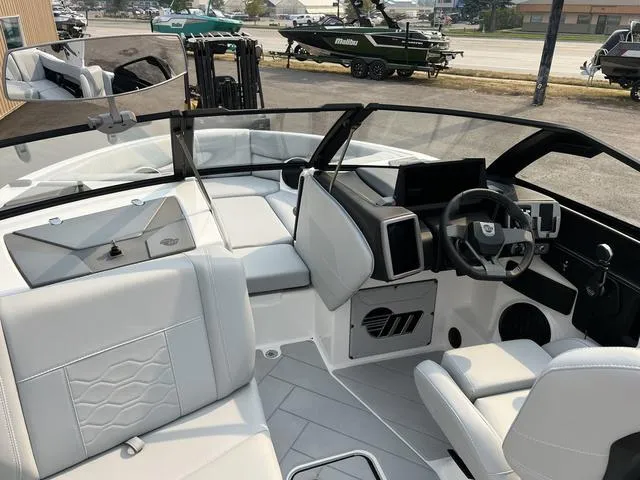 Slide: The Image of 2024 Malibu 23 LSV boat interior with modern dashboard and seating. - 11