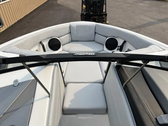 Slide: The Image of 2024 Malibu 23 LSV boat interior with white seating and black accents. - 12