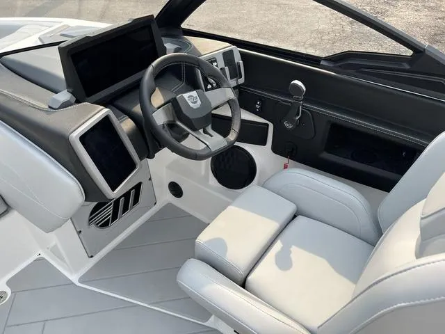 Slide: The Image of 2024 Malibu 23 LSV boat interior with modern dashboard and steering wheel. - 13