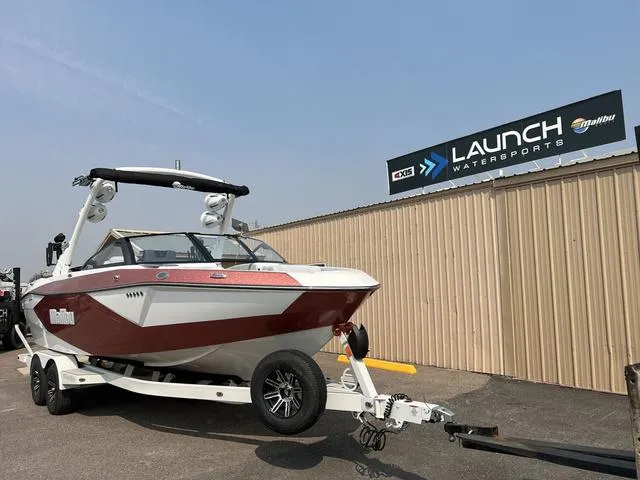 Slide: The Image of 2024 Malibu 23 LSV boat on trailer at Launch Watersports dealership. - 3
