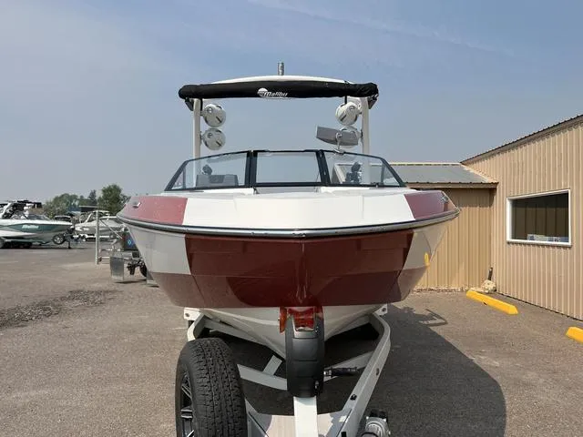 Slide: The Image of 2024 Malibu 23 LSV boat on trailer, front view, red and white color scheme. - 4