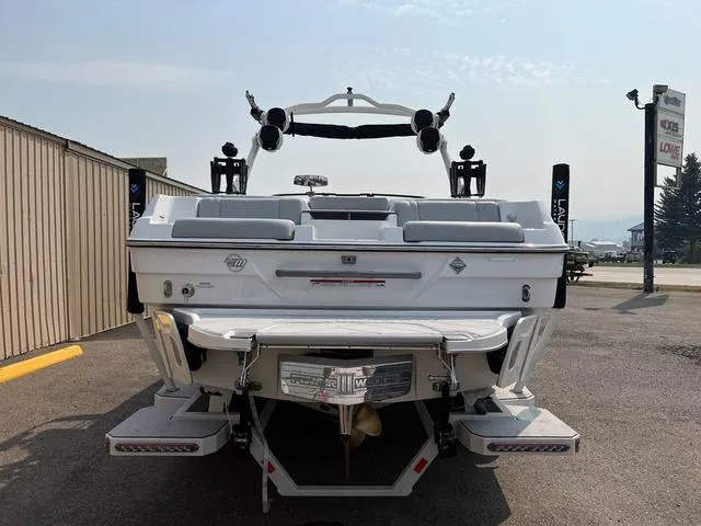 Slide: The Image of 2024 Malibu 23 LSV boat rear view in a parking lot. - 6