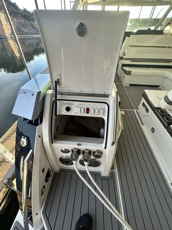 Slide: The Image of 2021 Formula 380 Super Sport Crossover boat interior with open control panel. - 11