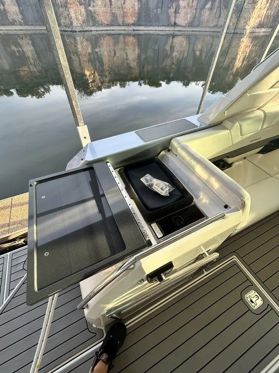 Slide: The Image of 2021 Formula 380 Super Sport Crossover yacht with open storage compartment on deck. - 13