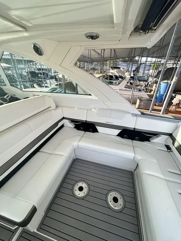 Slide: The Image of 2021 Formula 380 Super Sport Crossover boat interior with white seating and sleek design. - 14