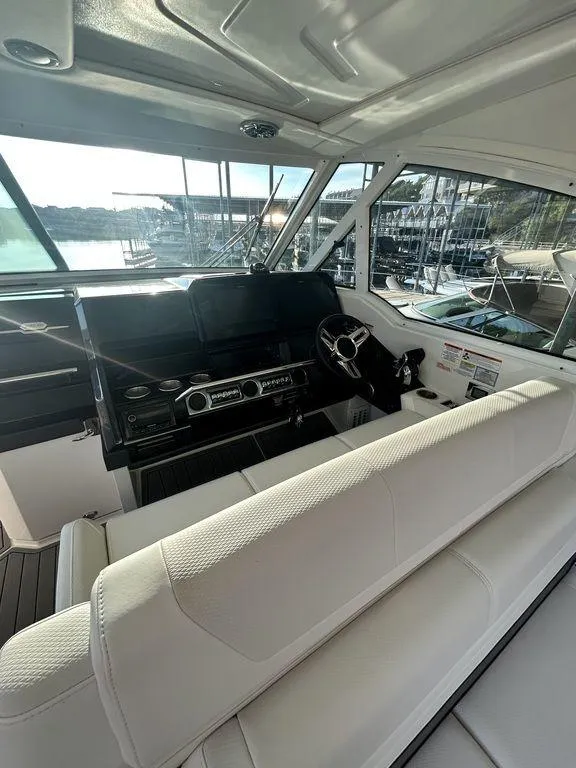 Slide: The Image of 2021 Formula 380 Super Sport Crossover boat interior with helm and seating. - 17
