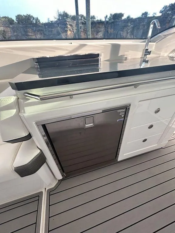 Slide: The Image of 2021 Formula 380 Super Sport Crossover yacht interior with sleek cabinetry and modern design. - 21