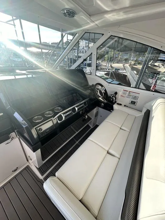 Slide: The Image of 2021 Formula 380 Super Sport Crossover cockpit with modern controls and white seating. - 26