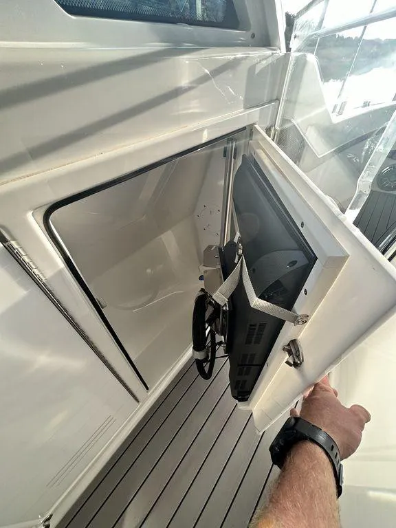 Slide: The Image of 2021 Formula 380 Super Sport Crossover boat with open storage compartment. - 27