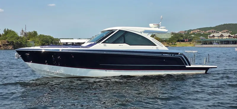 Slide: The Image of 2021 Formula 380 Super Sport Crossover boat on a scenic lake. - 3