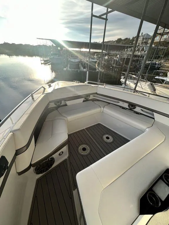 Slide: The Image of 2021 Formula 380 Super Sport Crossover boat with spacious seating at a marina. - 30
