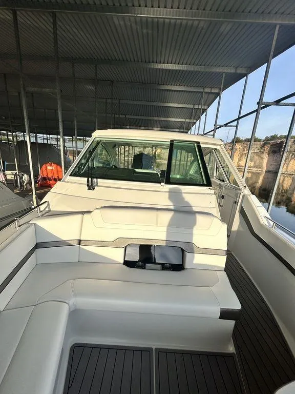 Slide: The Image of 2021 Formula 380 Super Sport Crossover boat docked in a covered marina. - 31