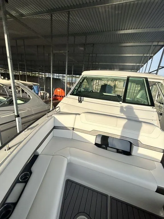 Slide: The Image of 2021 Formula 380 Super Sport Crossover boat docked in a covered marina. - 32