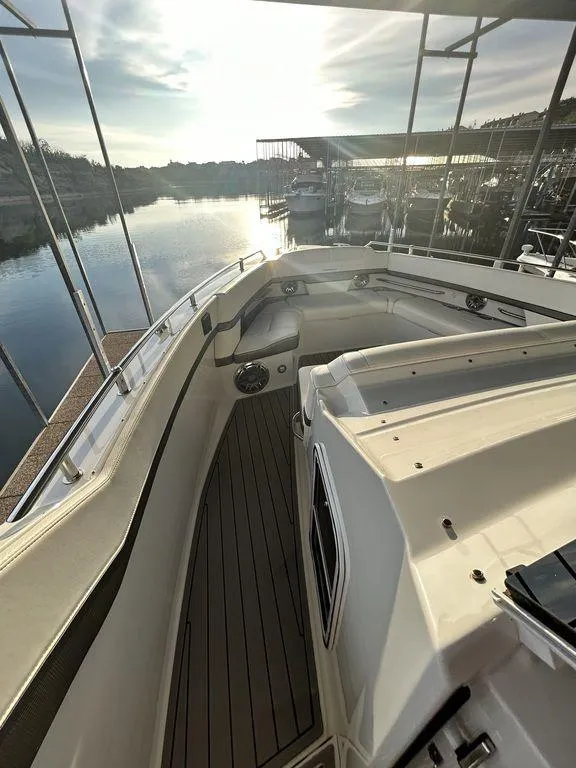 Slide: The Image of 2021 Formula 380 Super Sport Crossover boat docked, showcasing sleek design and spacious deck. - 33