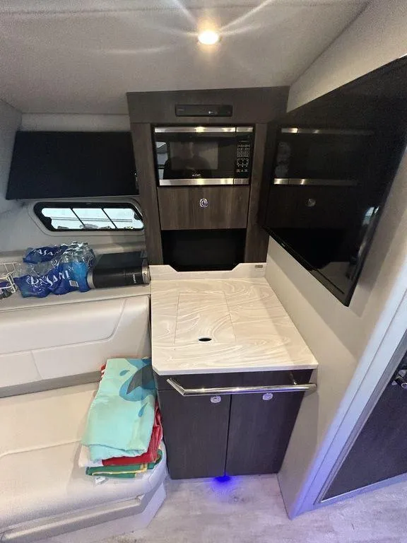 Slide: The Image of 2021 Formula 380 Super Sport Crossover interior with kitchenette and seating area. - 40