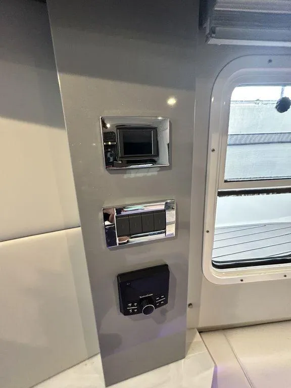 Slide: The Image of Control panel inside 2021 Formula 380 Super Sport Crossover boat, featuring modern switches and displays. - 41