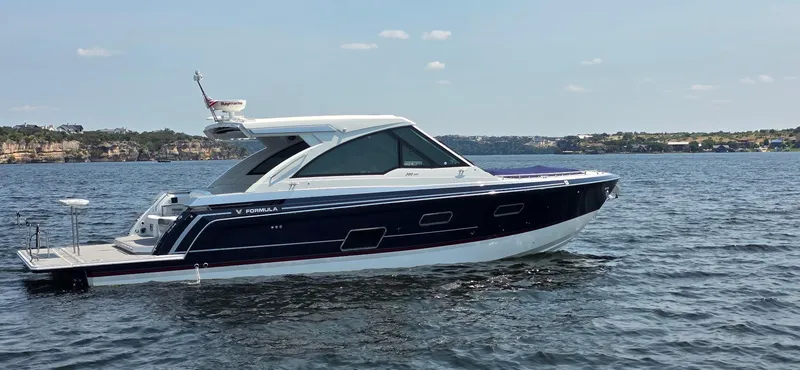 Slide: The Image of 2021 Formula 380 Super Sport Crossover boat on a calm lake. - 5