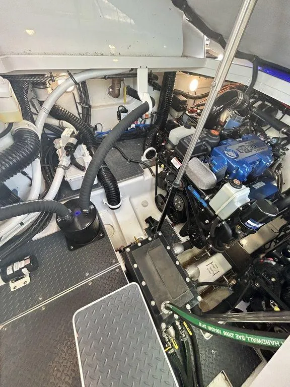 Slide: The Image of Engine compartment of a 2021 Formula 380 Super Sport Crossover boat, showcasing mechanical components. - 56