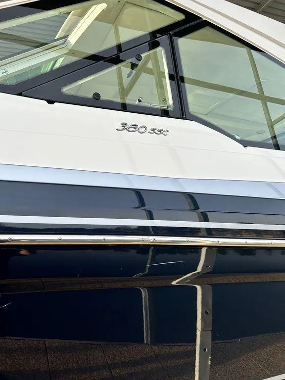 Slide: The Image of 2021 Formula 380 Super Sport Crossover boat, sleek design with reflective windows. - 7