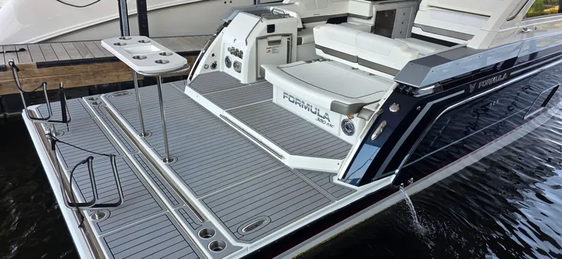 Slide: The Image of 2021 Formula 380 Super Sport Crossover boat with spacious deck and seating area. - 9