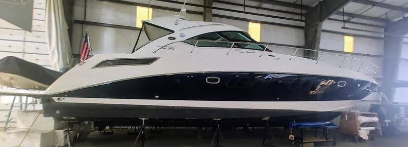 Slide: The Image of 2010 Sea Ray 540 Sundancer yacht in indoor storage facility. - 0
