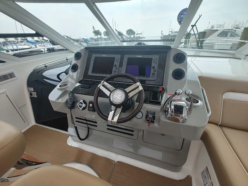 Slide: The Image of Helm of 2010 Sea Ray 540 Sundancer with advanced navigation systems. - 12