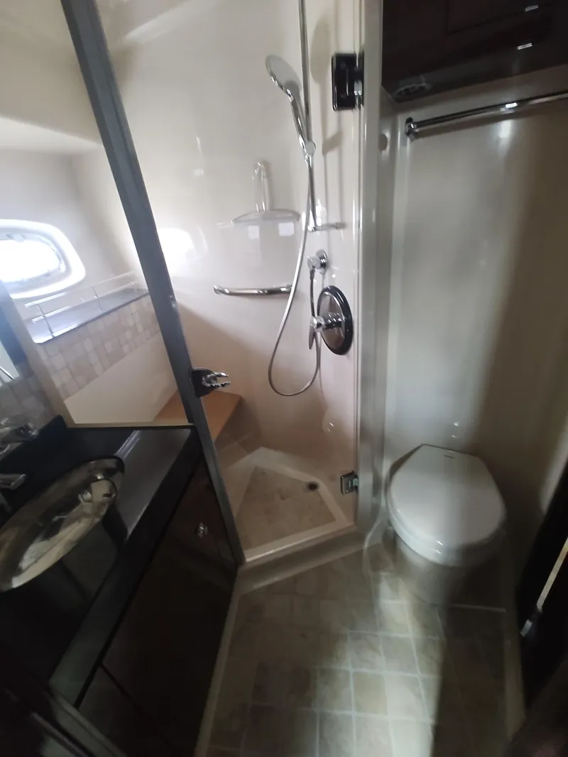 Slide: The Image of 2010 Sea Ray 540 Sundancer bathroom with shower, sink, and toilet. - 18