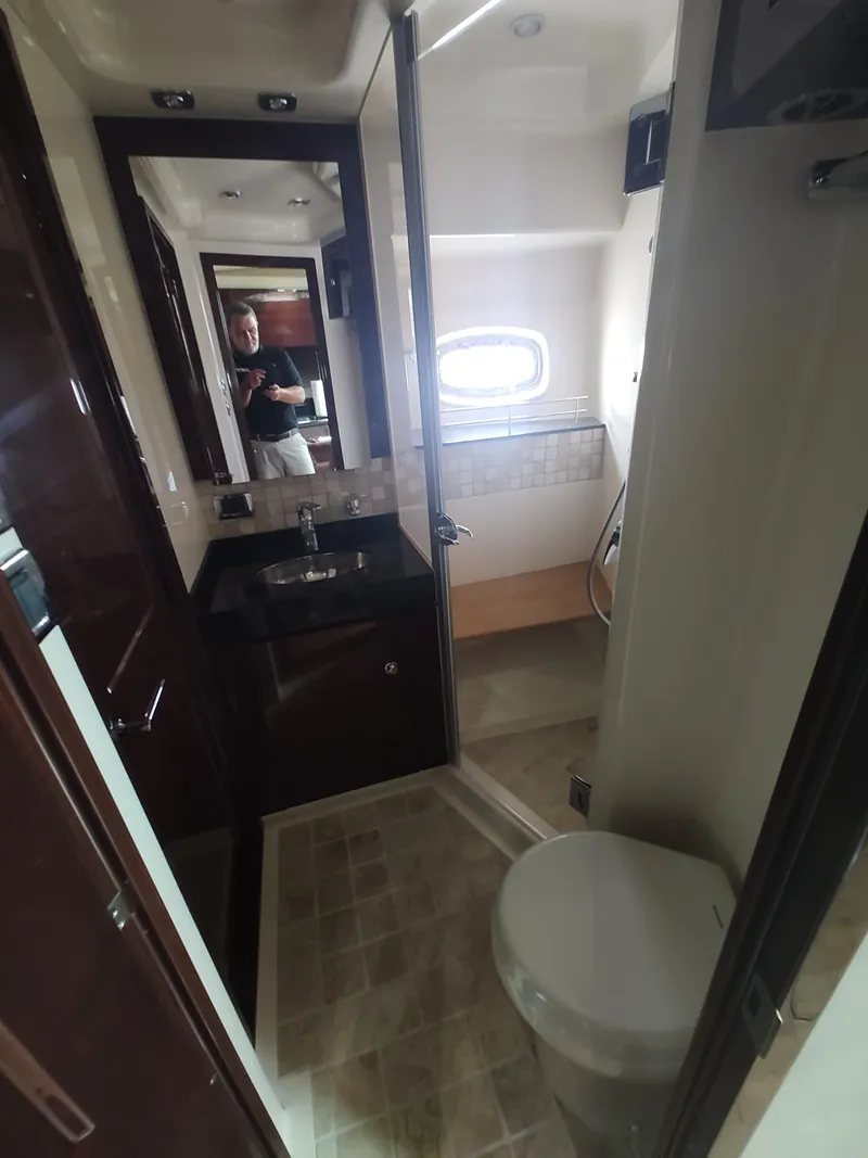 Slide: The Image of Bathroom interior of a 2010 Sea Ray 540 Sundancer yacht with sink, toilet, and shower. - 22