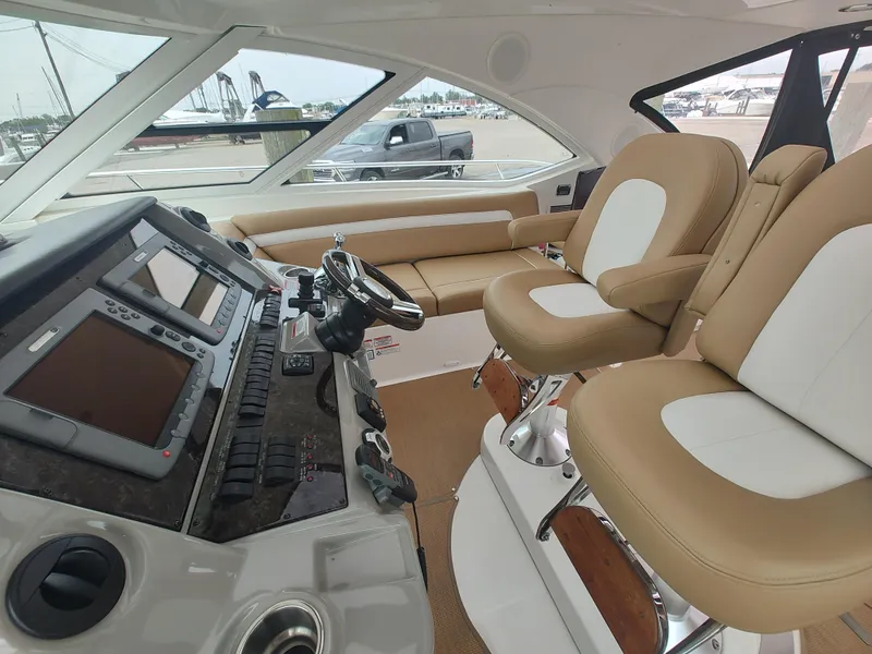 Slide: The Image of 2010 Sea Ray 540 Sundancer helm with dual captain chairs and advanced navigation system. - 4