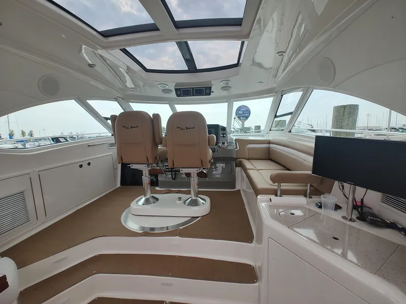 Slide: The Image of Interior of 2010 Sea Ray 540 Sundancer yacht with helm chairs and panoramic windows. - 6